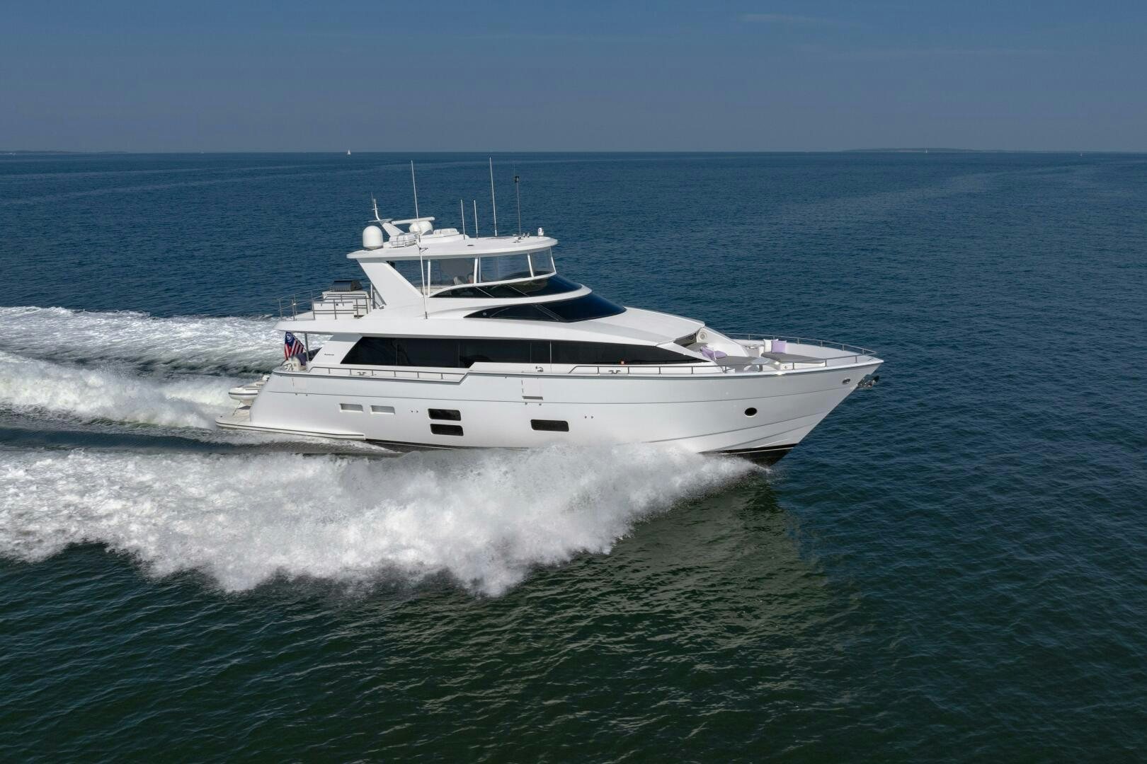 a white yacht in the ocean aboard IMAGINE Yacht for Sale