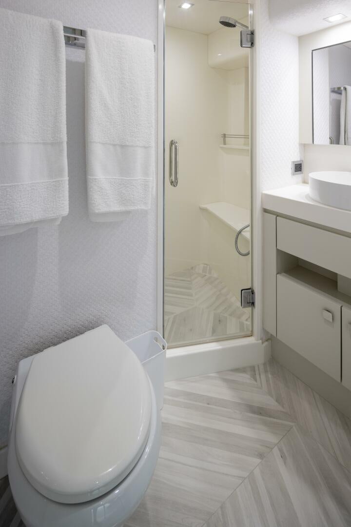 a bathroom with a glass shower door aboard IMAGINE Yacht for Sale
