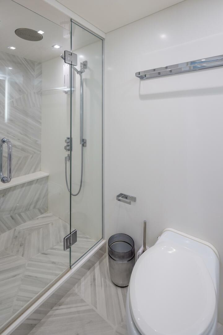 a bathroom with a glass shower aboard IMAGINE Yacht for Sale