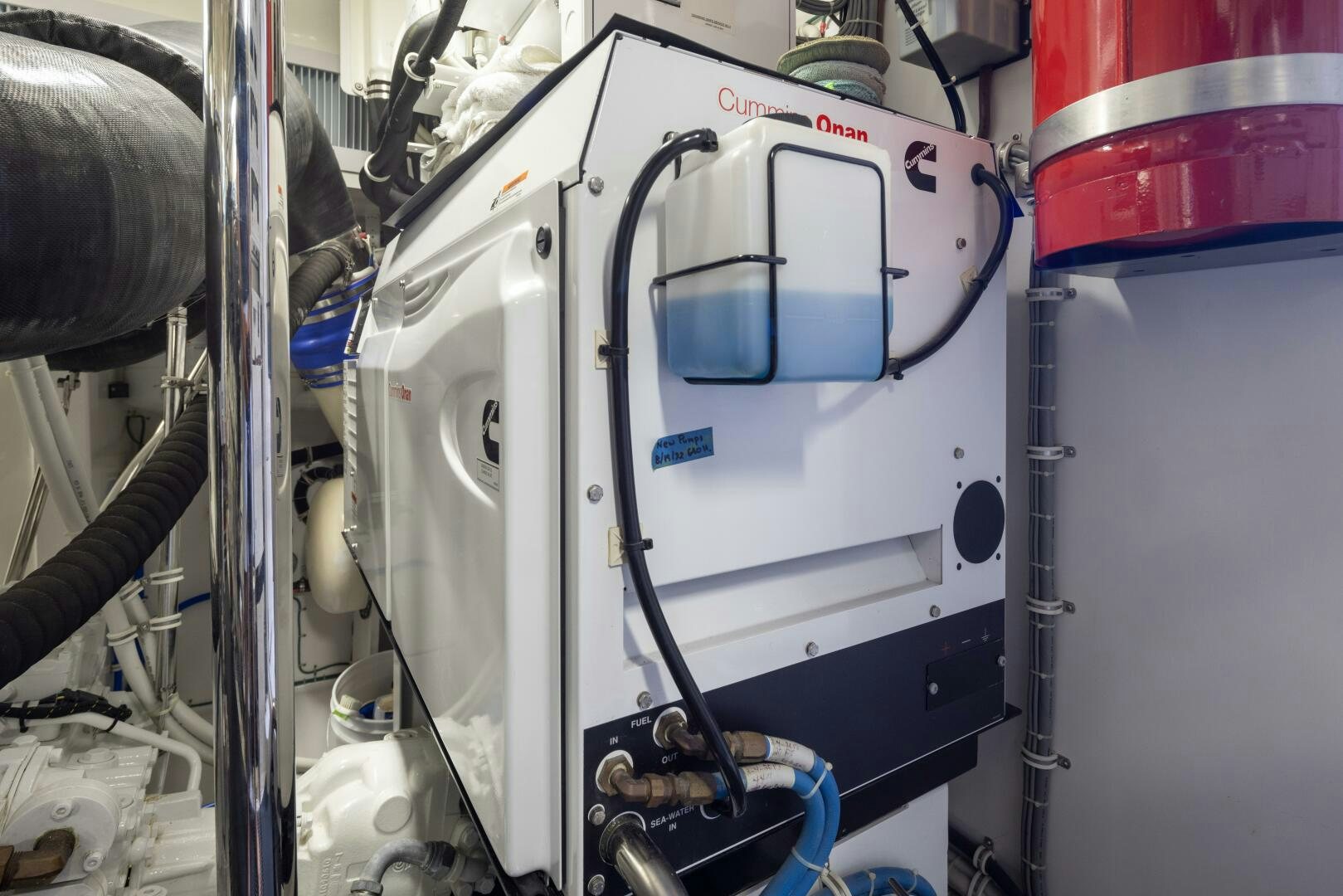 a white machine with a red and blue label aboard IMAGINE Yacht for Sale