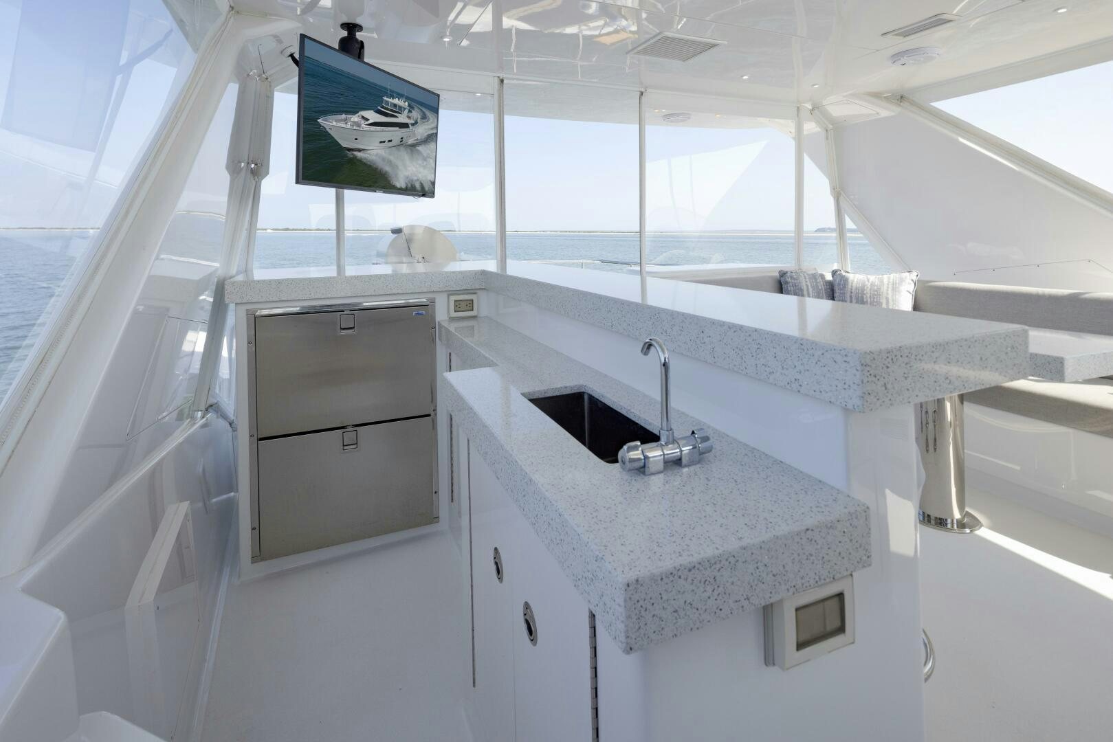 a white bathroom with a sink and cabinets aboard IMAGINE Yacht for Sale