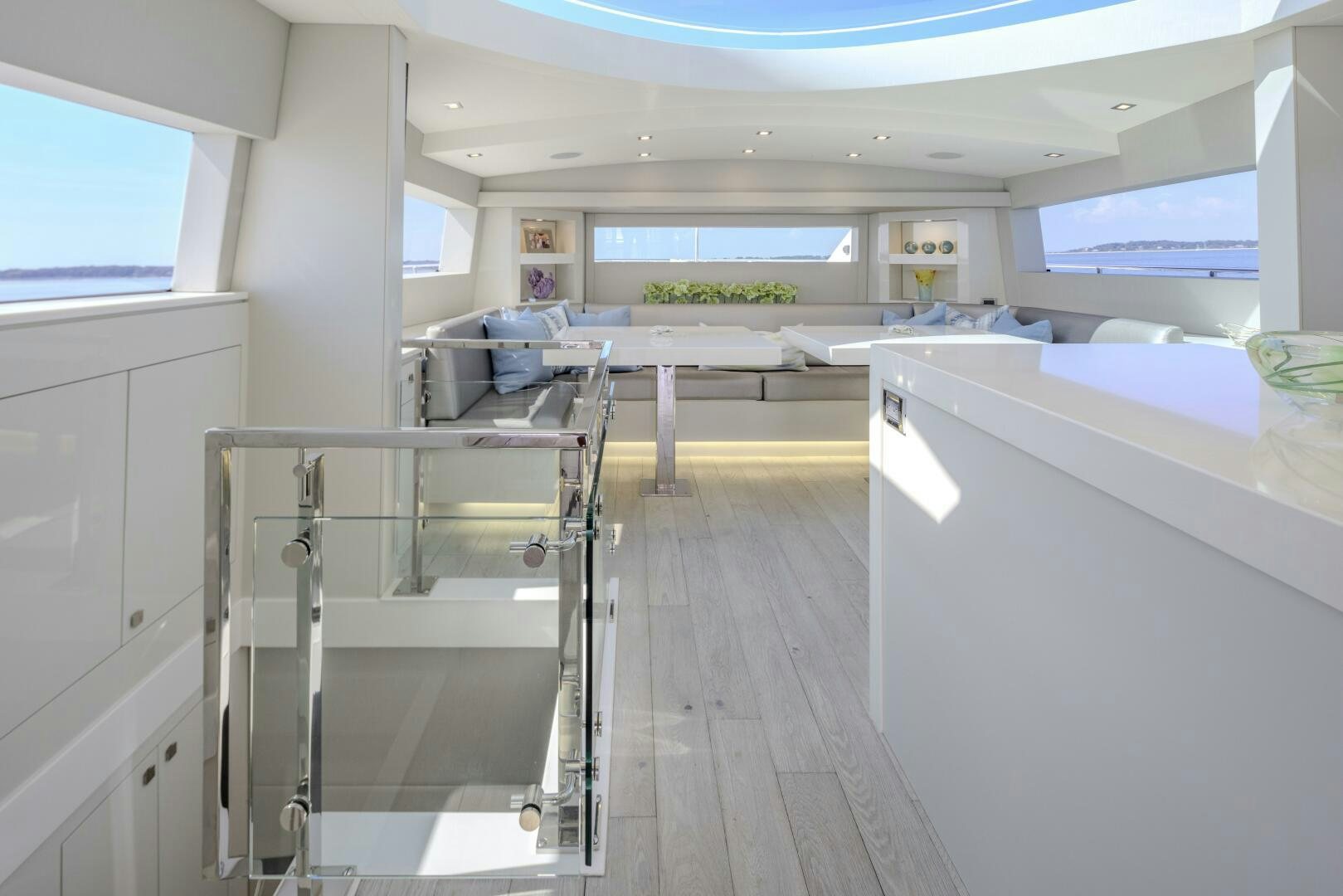 a room with white cabinets and a table and chairs aboard IMAGINE Yacht for Sale