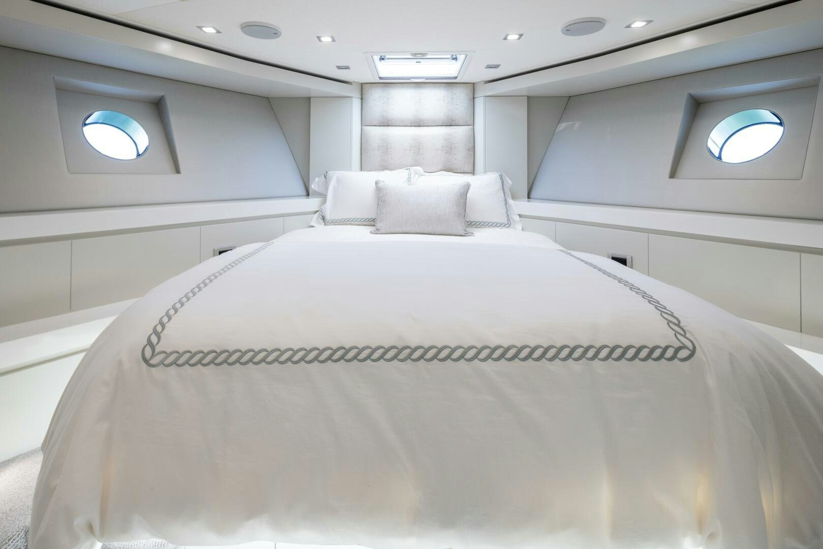 a white bed in a room aboard IMAGINE Yacht for Sale