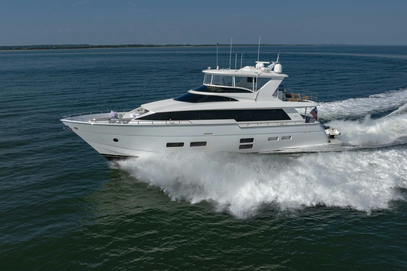 a white yacht on the water aboard IMAGINE Yacht for Sale