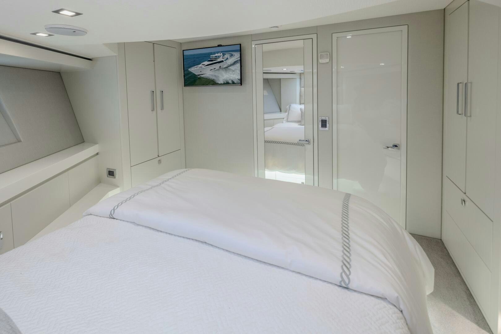 a white bed in a room aboard IMAGINE Yacht for Sale