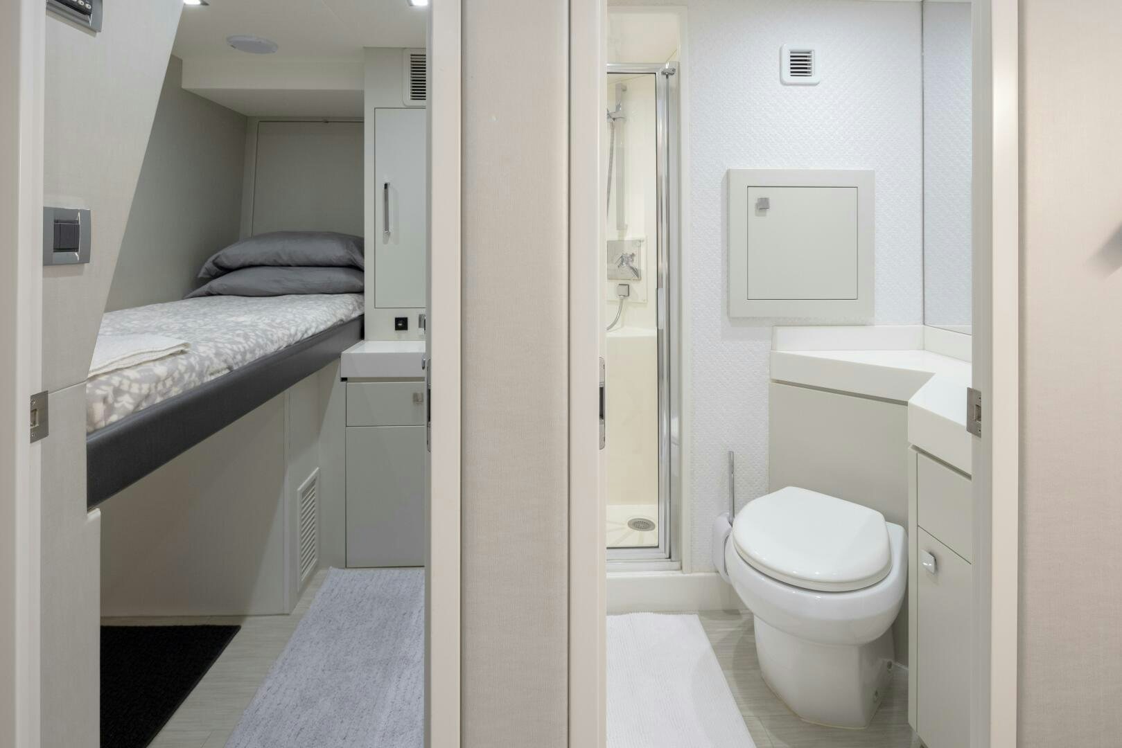 a white bathroom with a white toilet aboard IMAGINE Yacht for Sale