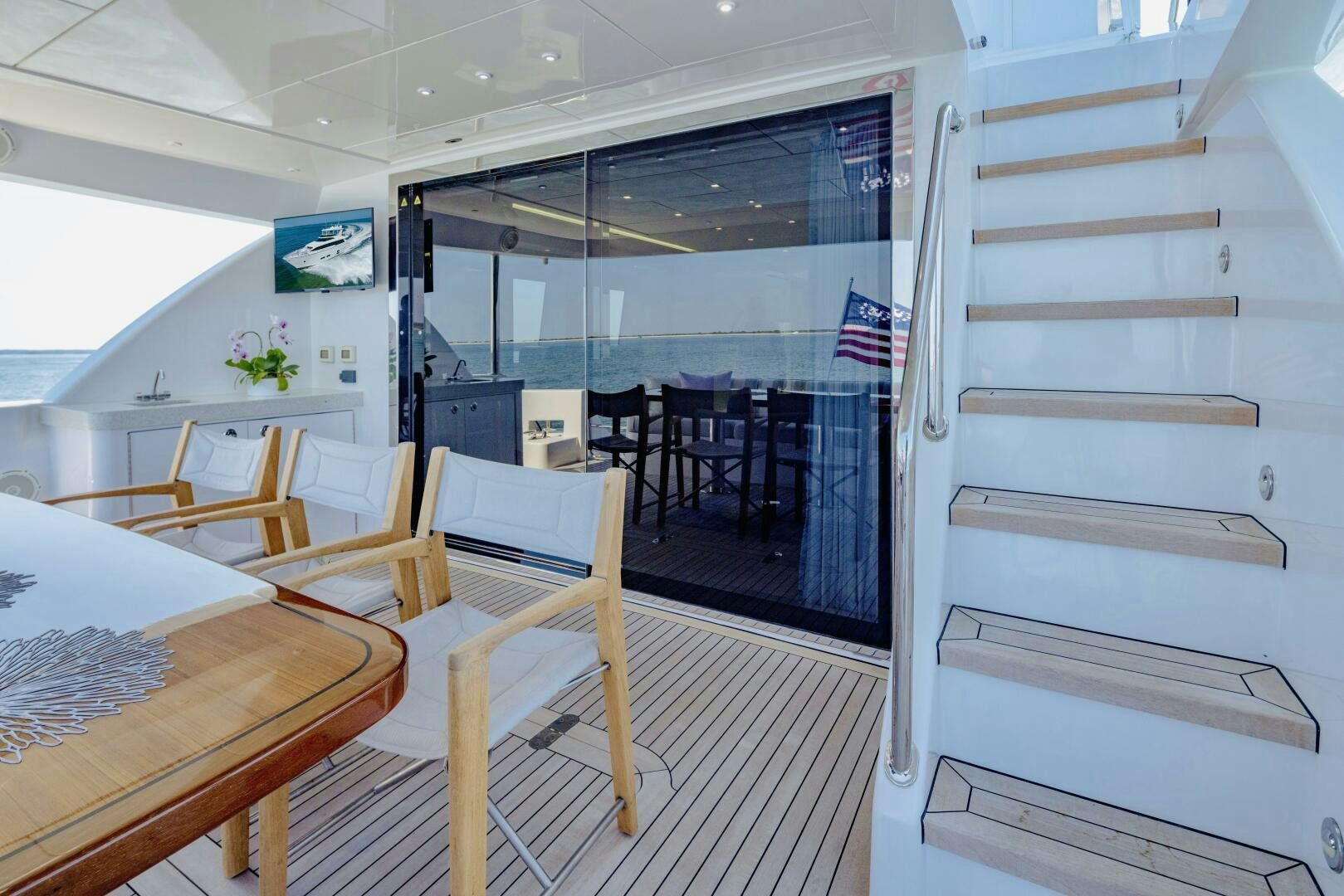 a room with tables and chairs aboard IMAGINE Yacht for Sale