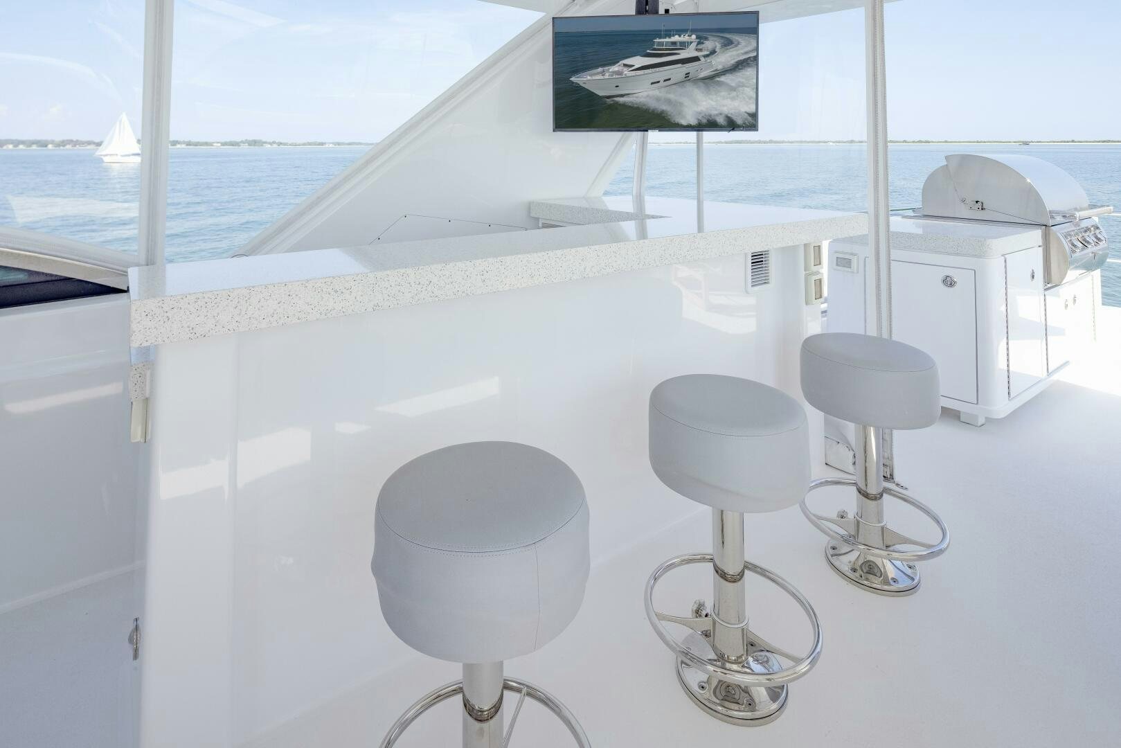 a group of stools on a white table aboard IMAGINE Yacht for Sale