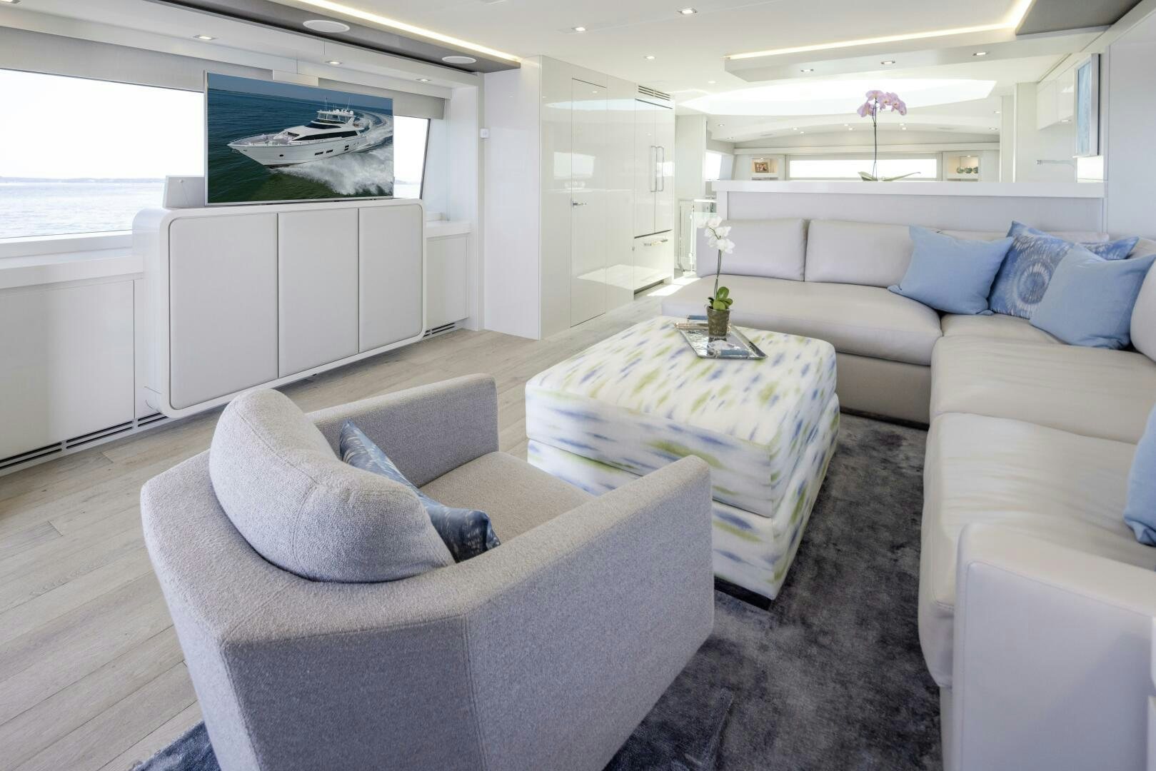 a living room with a couch and a table aboard IMAGINE Yacht for Sale
