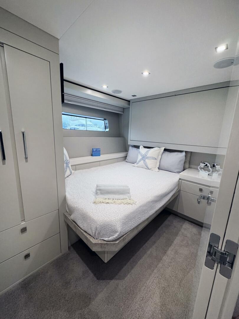 a room with a bed and a window aboard IMAGINE Yacht for Sale