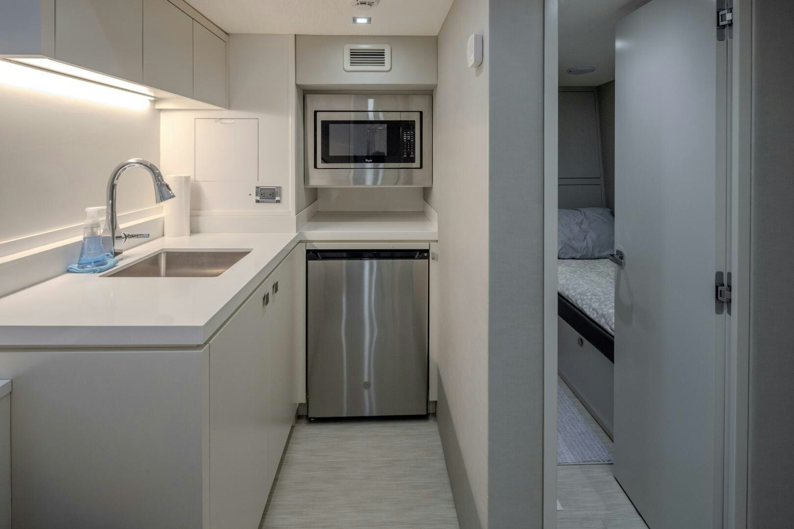 a kitchen with a sink and a microwave aboard IMAGINE Yacht for Sale