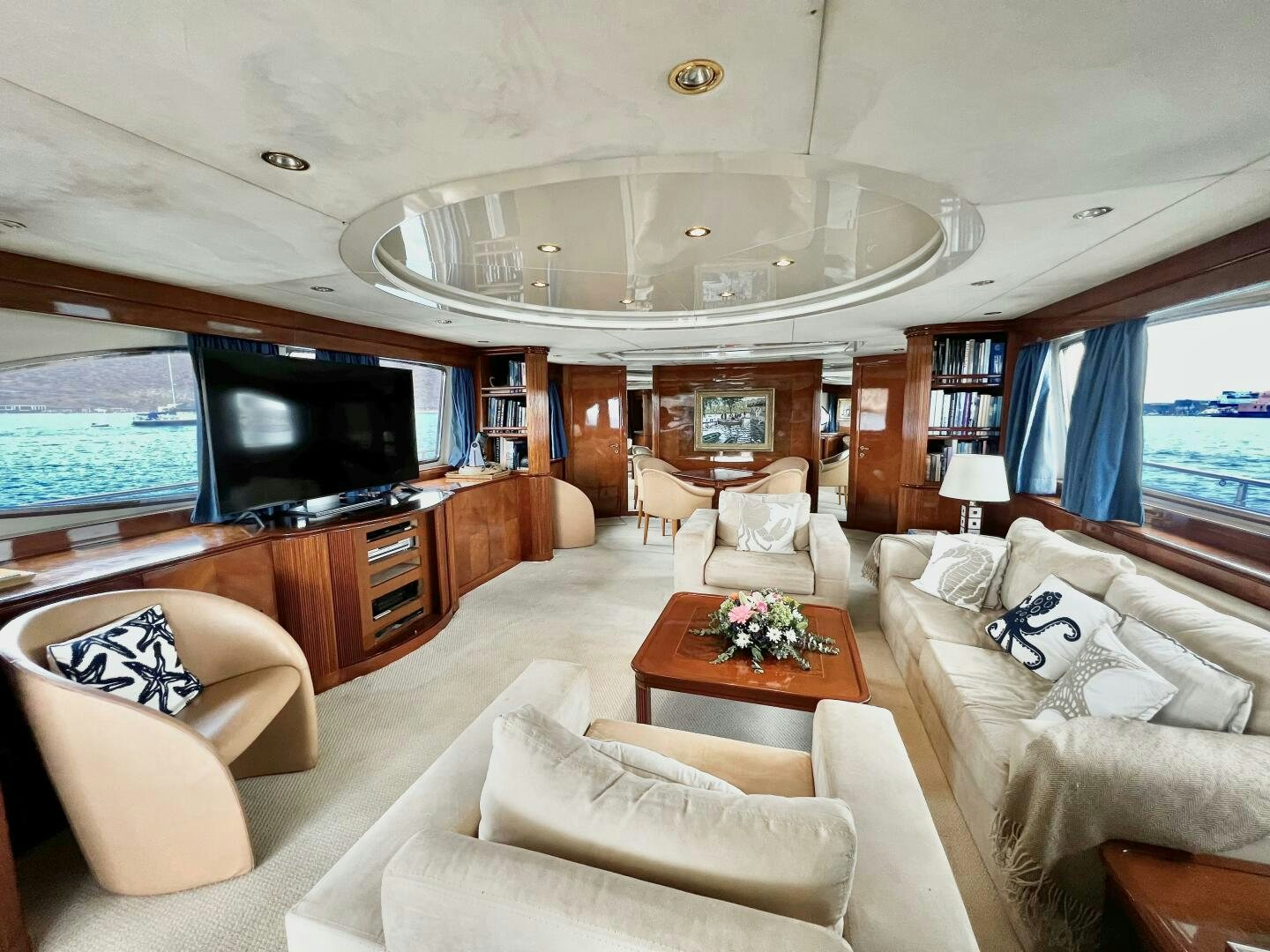 a living room with a large chandelier aboard GARI Yacht for Sale