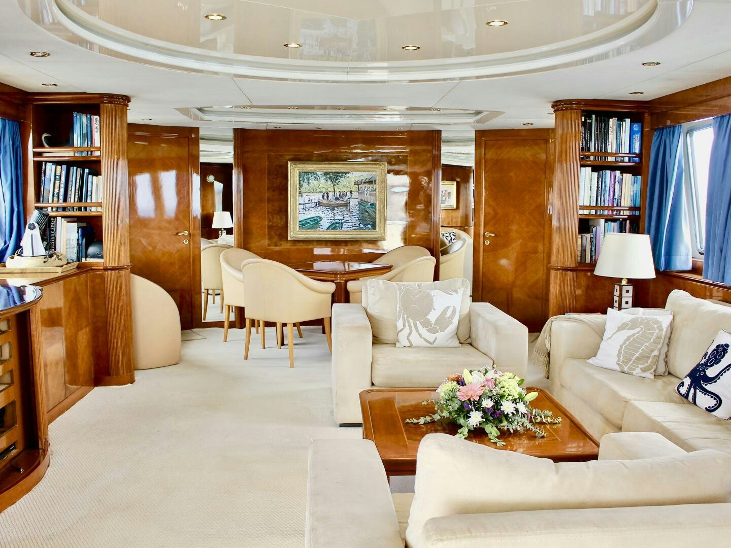 a living room with a table and chairs aboard GARI Yacht for Sale