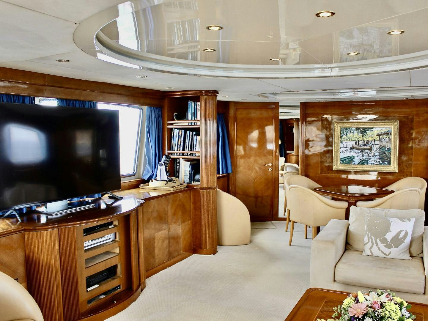 a living room with a tv and furniture aboard GARI Yacht for Sale
