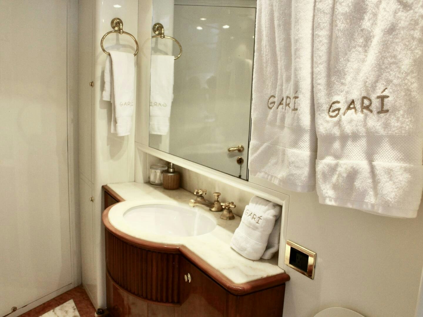 a bathroom with a sink and a mirror aboard GARI Yacht for Sale