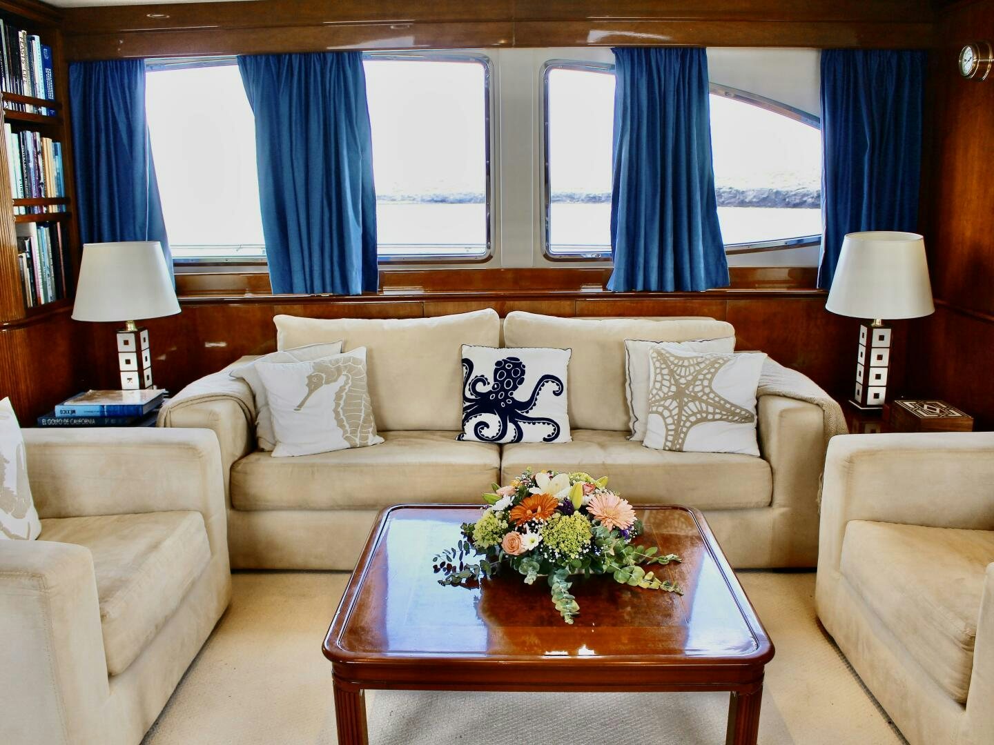 a living room with a couch and a table aboard GARI Yacht for Sale