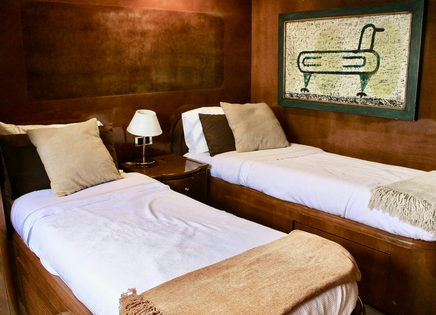 a couple of beds in a hotel room aboard GARI Yacht for Sale
