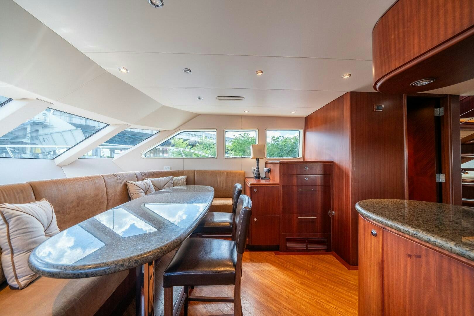a living room with a table and couches aboard E Yacht for Sale