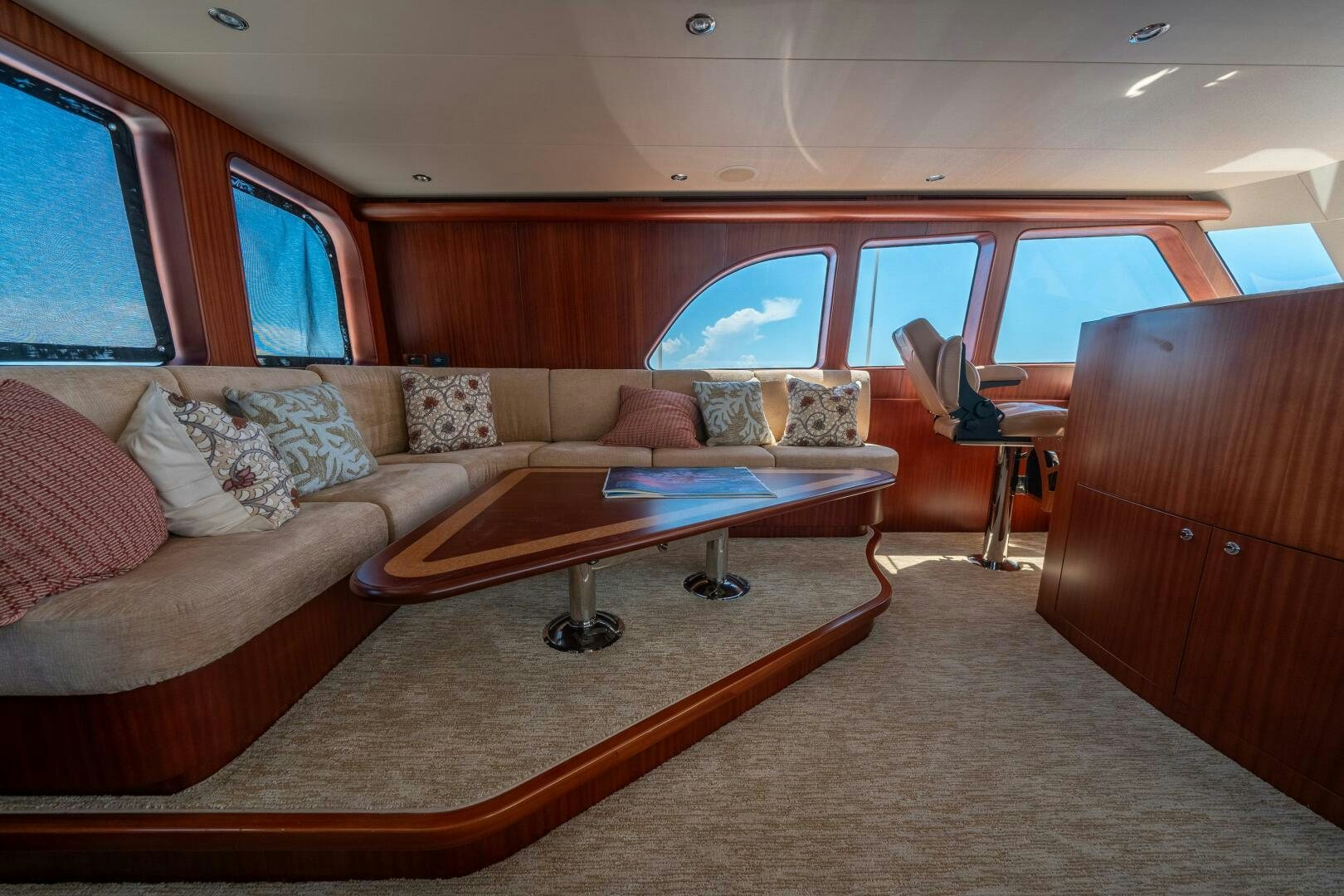 a living room with a couch and a table aboard E Yacht for Sale