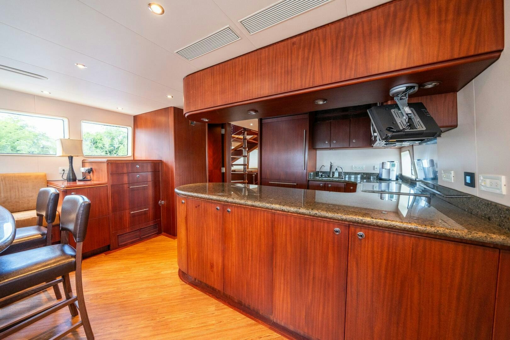 a kitchen with wooden cabinets aboard E Yacht for Sale