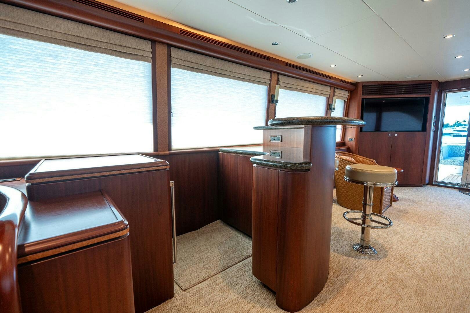 a room with a table and chairs aboard E Yacht for Sale