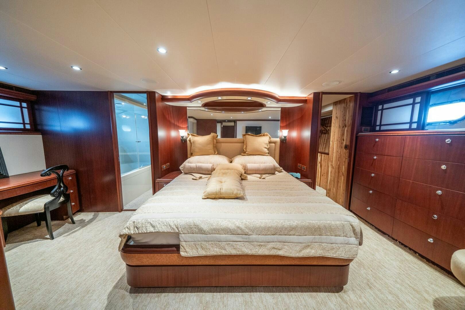 a bedroom with a bed and a desk aboard E Yacht for Sale