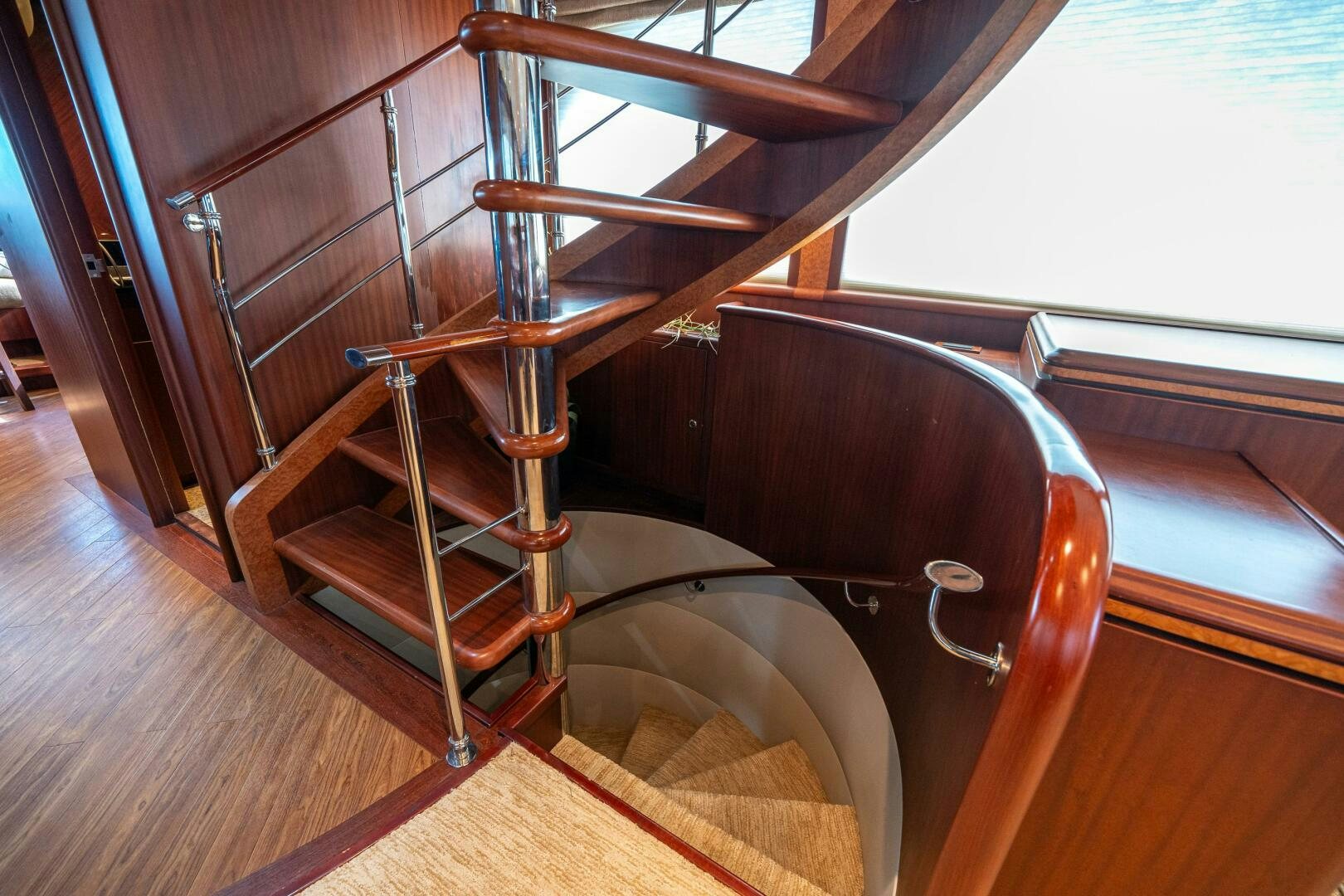 a wooden chair with a metal frame aboard E Yacht for Sale