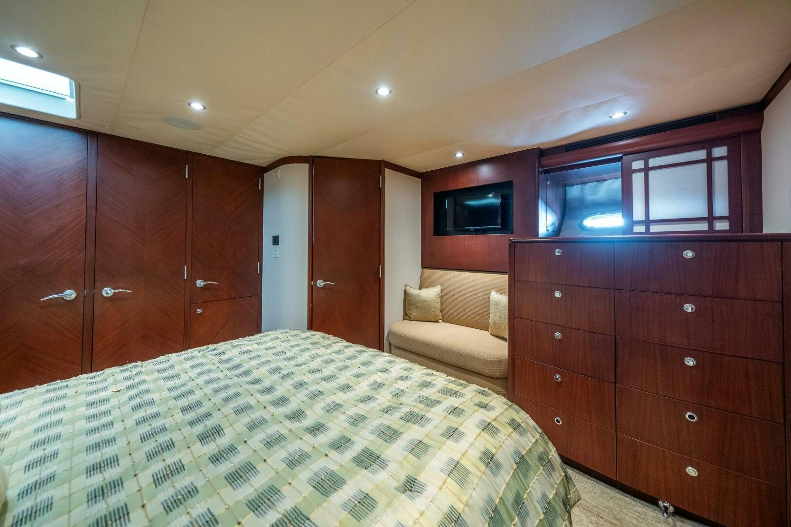 a bedroom with a bed and a dresser aboard E Yacht for Sale