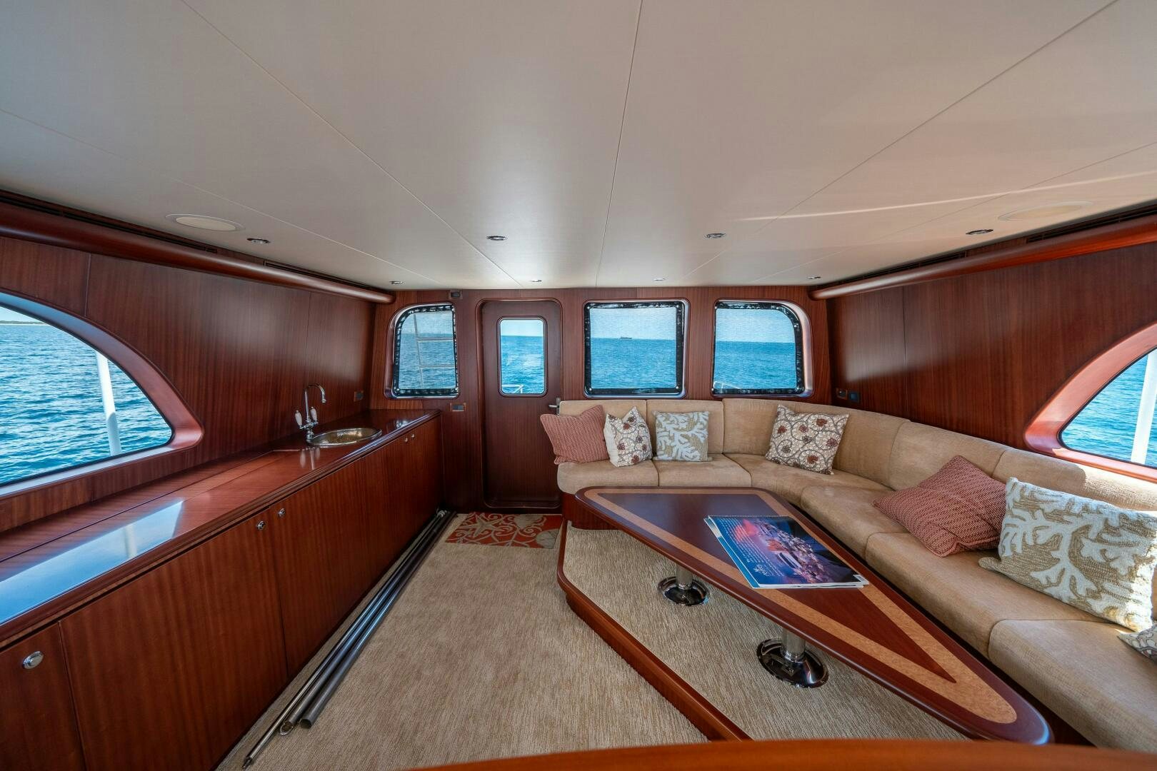 a living room with a couch and a table aboard E Yacht for Sale