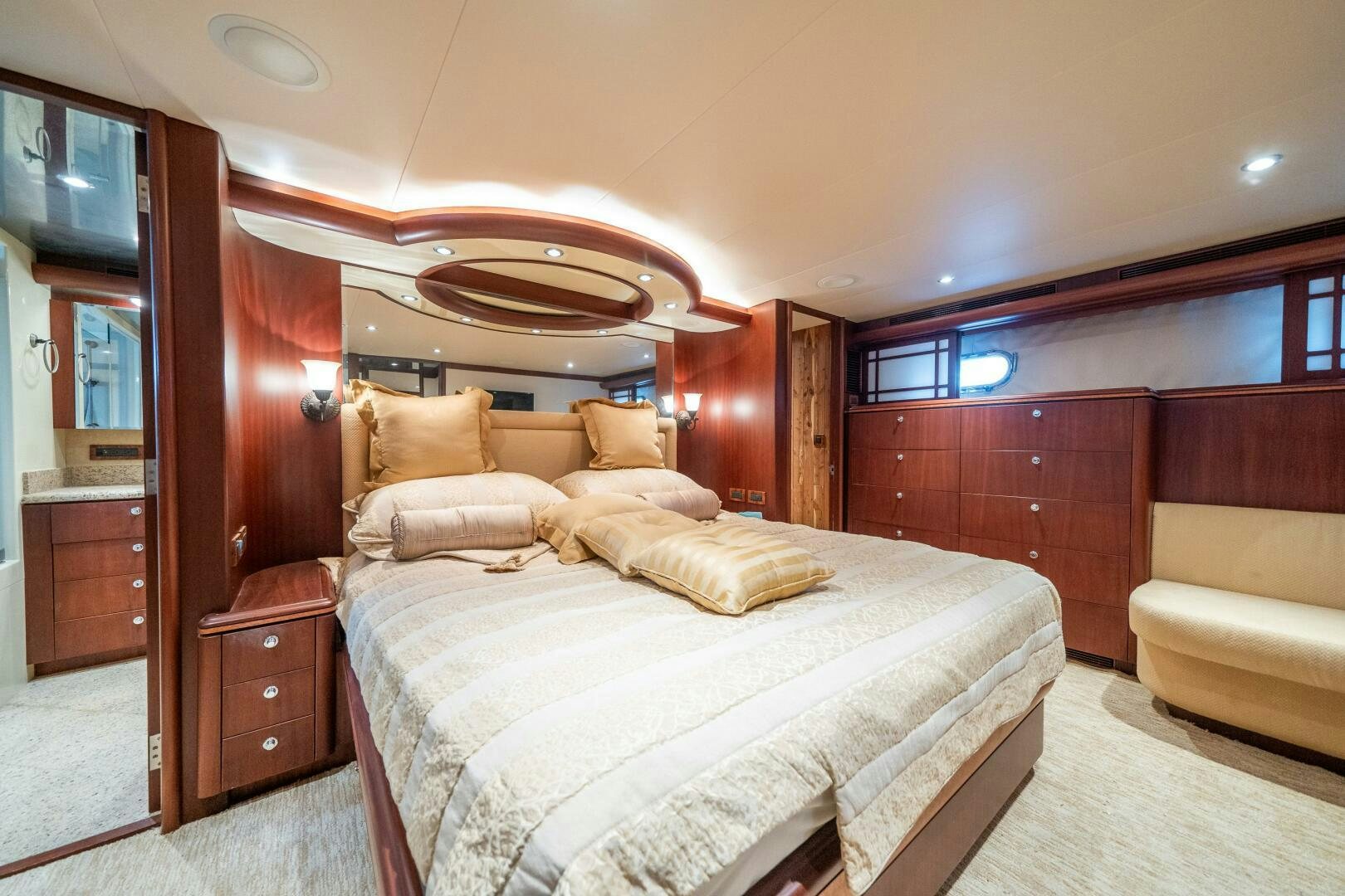 a bedroom with a bed and a couch aboard E Yacht for Sale