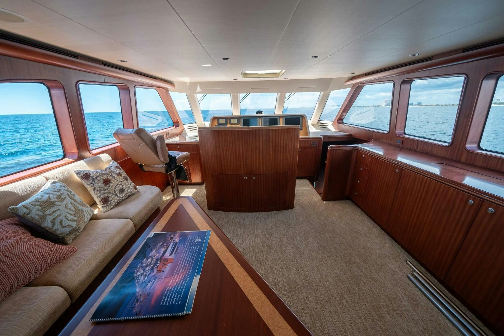 a living room with a couch and a table aboard E Yacht for Sale