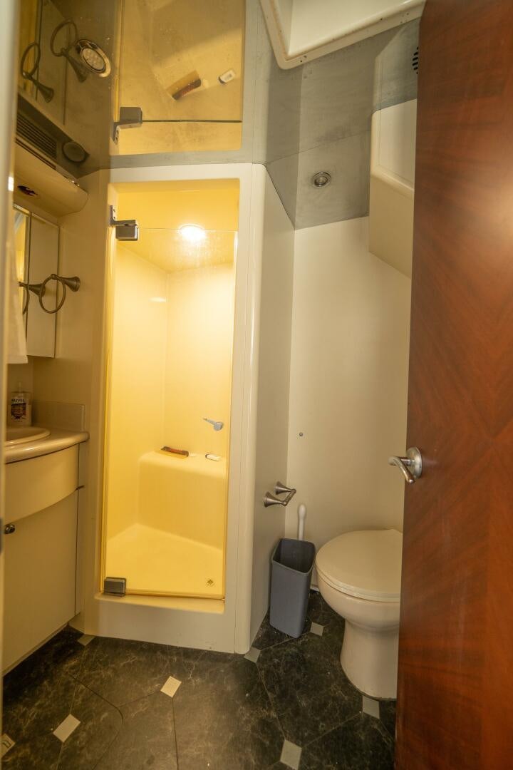 a bathroom with a toilet and a sink aboard E Yacht for Sale