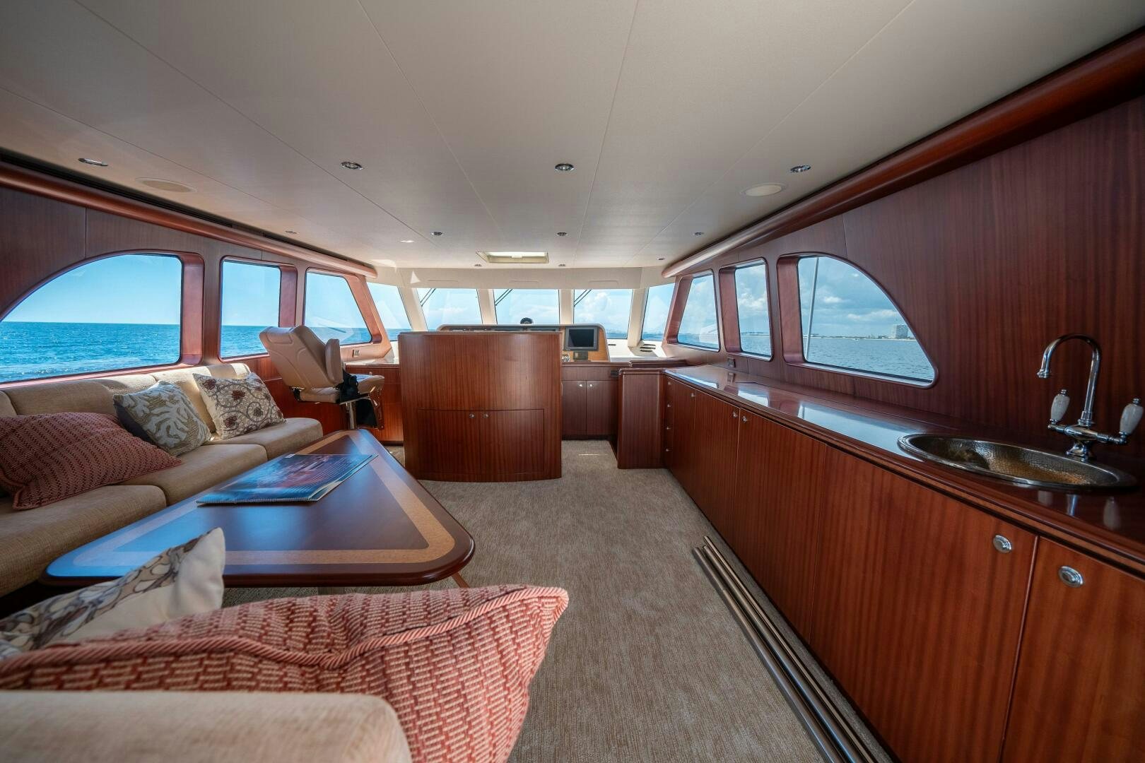 a living room with a couch and a table aboard E Yacht for Sale