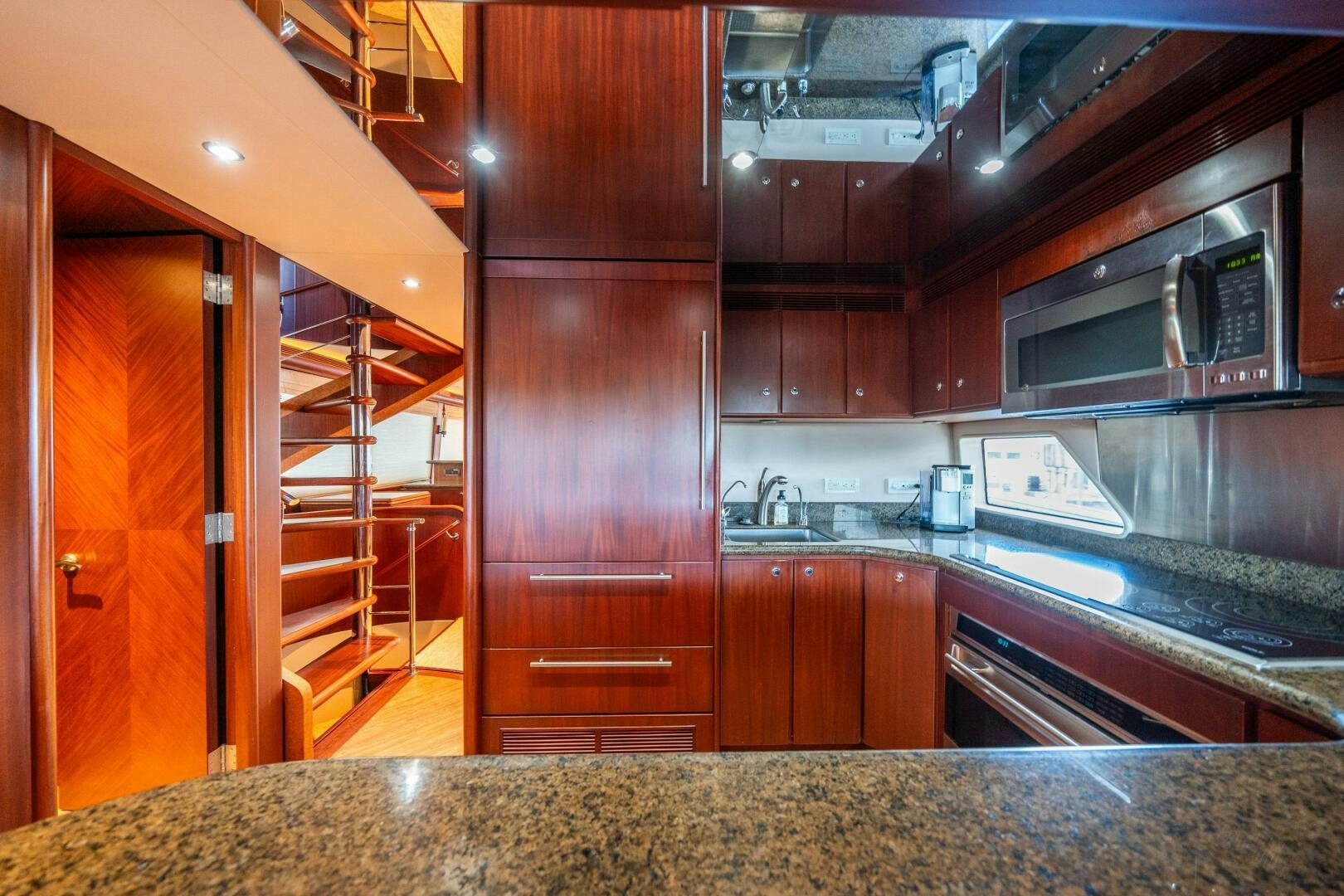 a kitchen with wooden cabinets aboard E Yacht for Sale