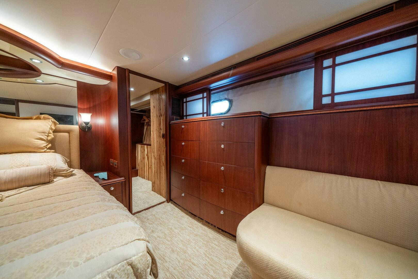 a room with a bed and a couch aboard E Yacht for Sale