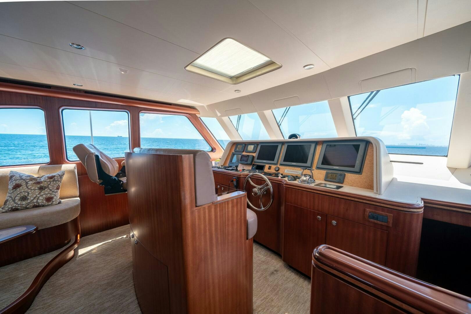 inside of a vehicle with a desk and chairs aboard E Yacht for Sale