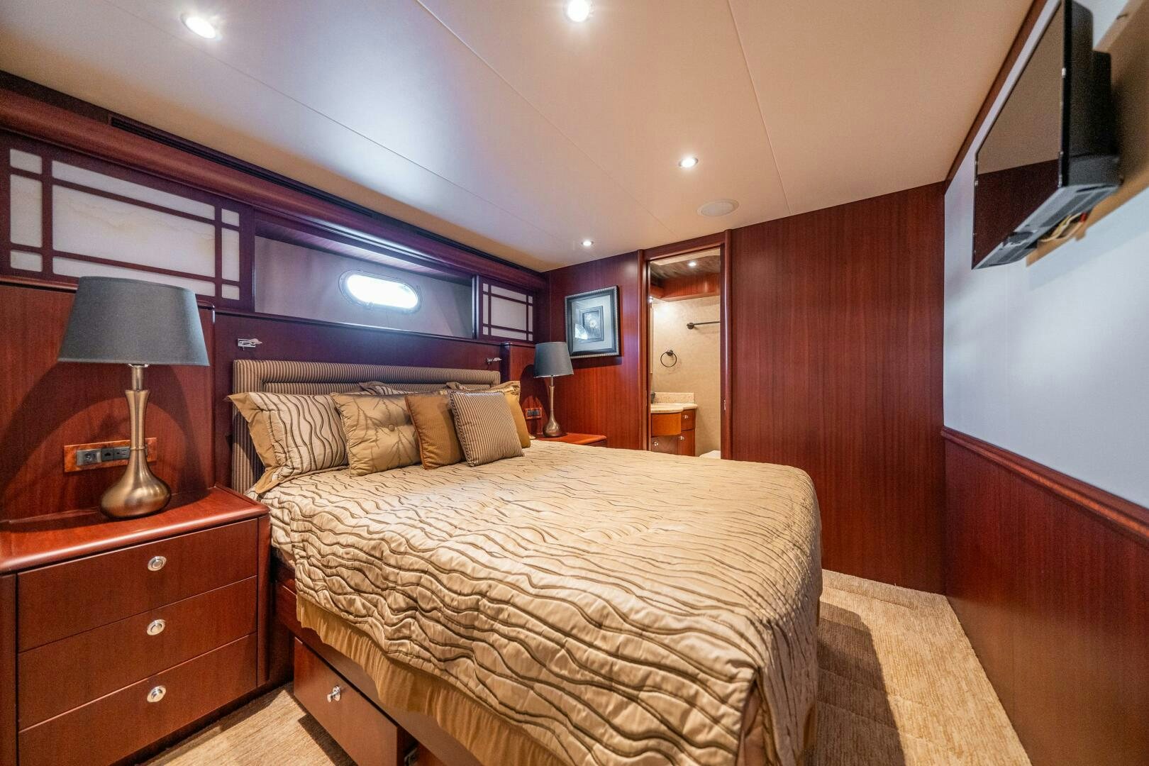 a bedroom with a bed and a mirror aboard E Yacht for Sale
