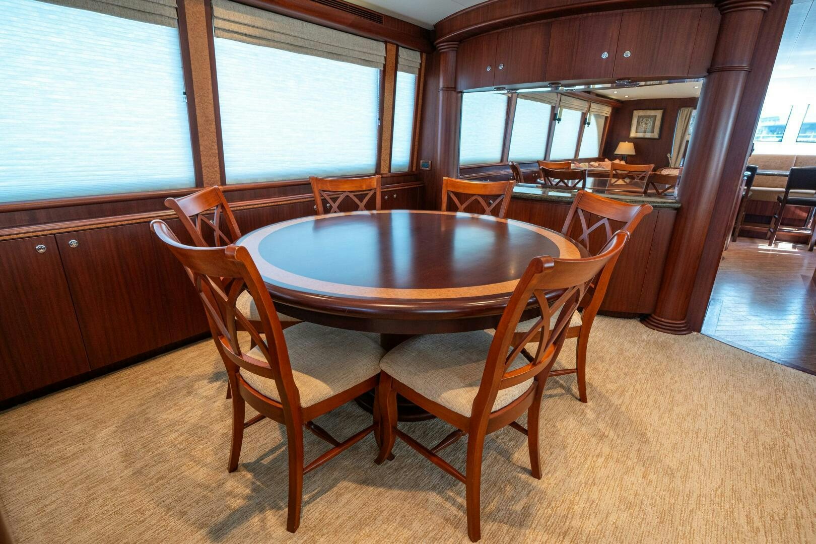 a table and chairs in a room aboard E Yacht for Sale