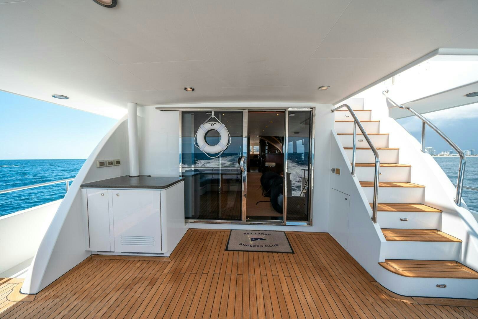 a large white and blue house with a wooden floor and a large swimming pool aboard E Yacht for Sale
