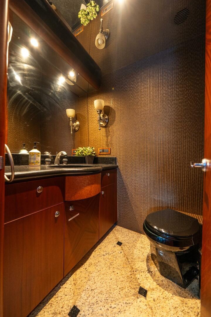a bathroom with a sink and a trash can aboard E Yacht for Sale
