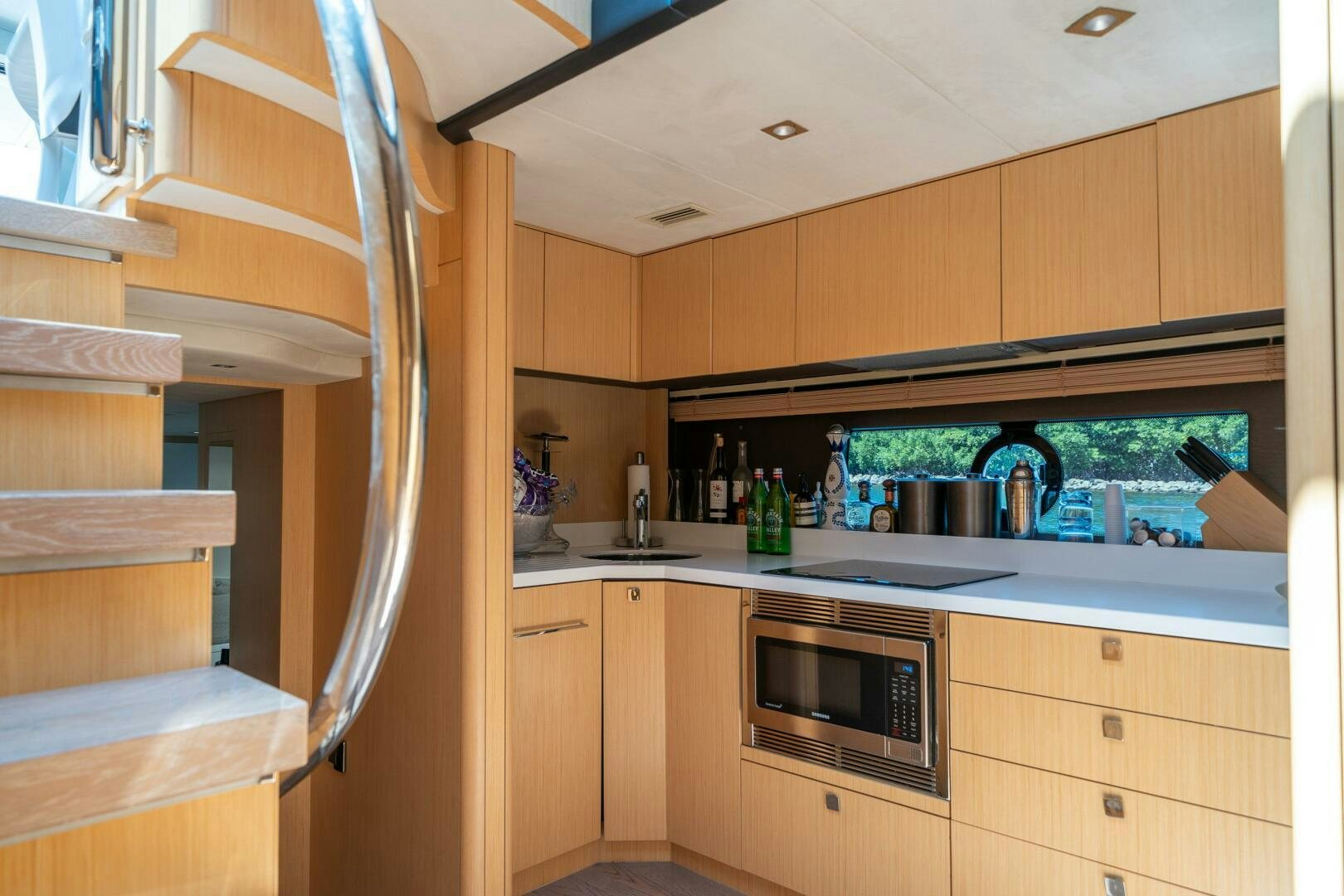 a kitchen with wooden cabinets aboard MYLE Yacht for Sale