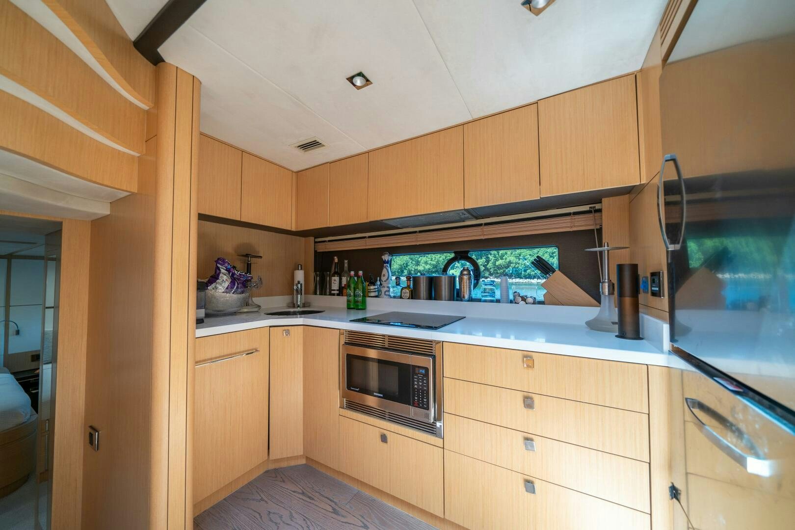 a kitchen with wooden cabinets aboard MYLE Yacht for Sale