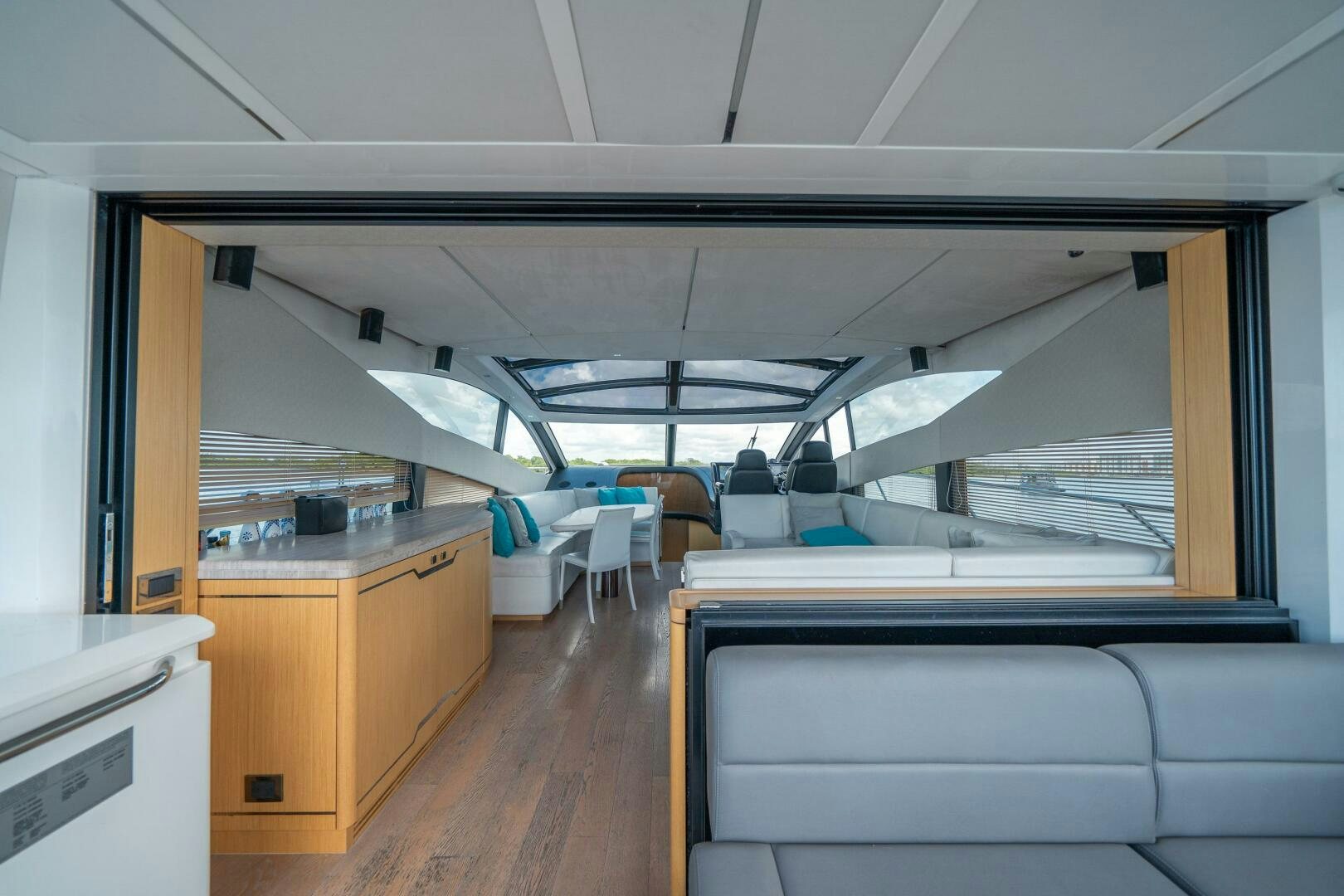 a room with a wood floor and a large window aboard MYLE Yacht for Sale