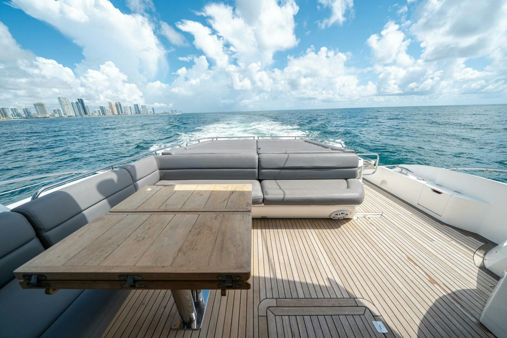 a deck with a view of a city and water aboard MYLE Yacht for Sale