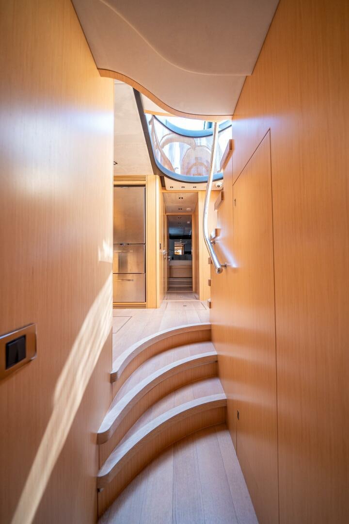 a hallway with a glass door aboard MYLE Yacht for Sale