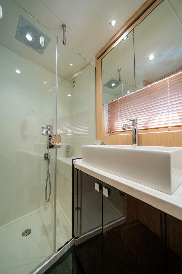 a bathroom with a glass shower aboard MYLE Yacht for Sale