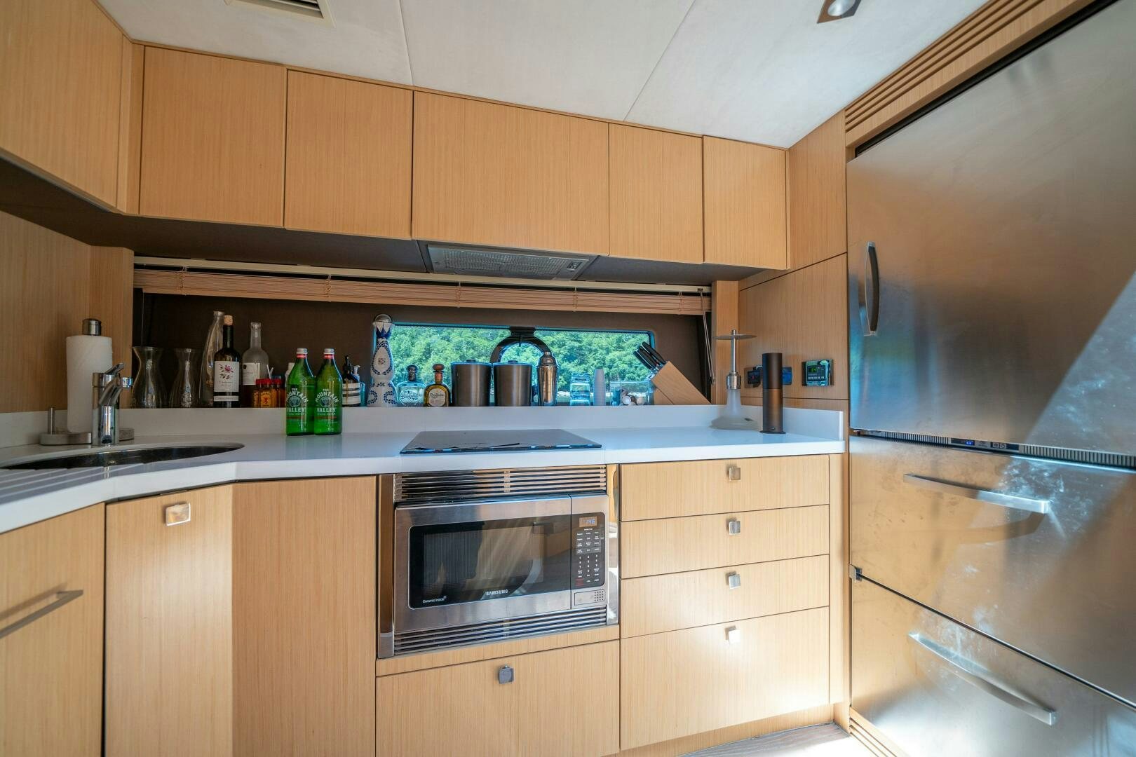 a kitchen with wooden cabinets aboard MYLE Yacht for Sale