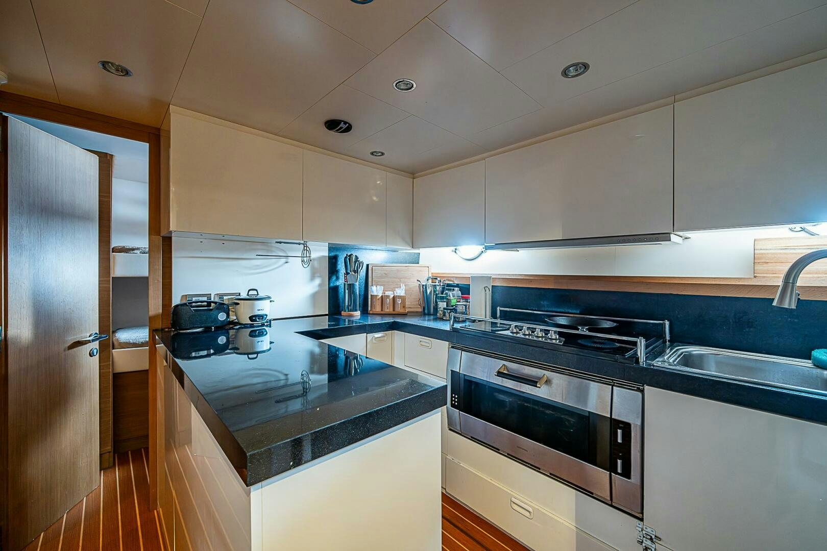 a kitchen with white cabinets aboard INTERVENTION Yacht for Sale