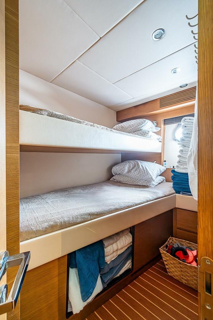 a bunk bed with a blue pillow aboard INTERVENTION Yacht for Sale
