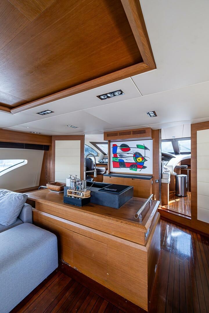 a living room with a wood table aboard INTERVENTION Yacht for Sale